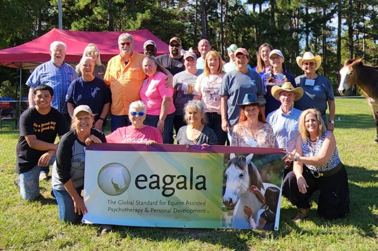 Group of Eagala participants with banner